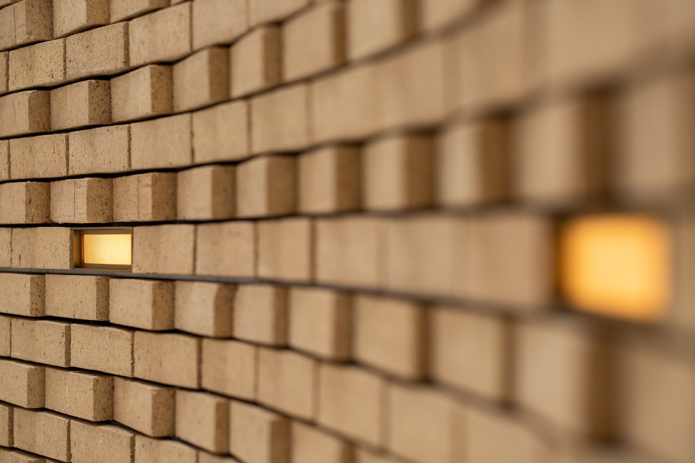 Brick light in pale brown masonry wall